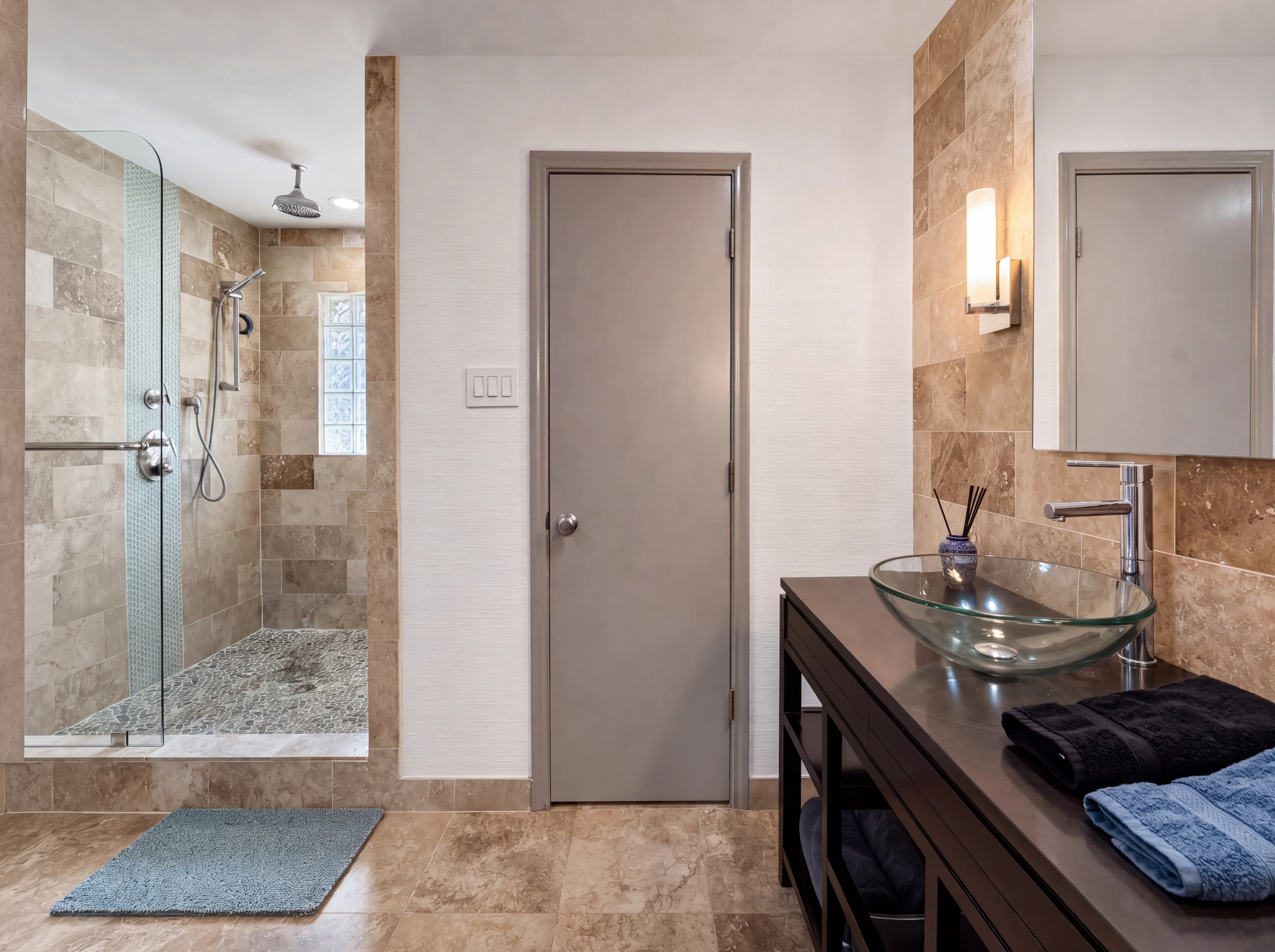 Oversized travertine shower with rainfall head